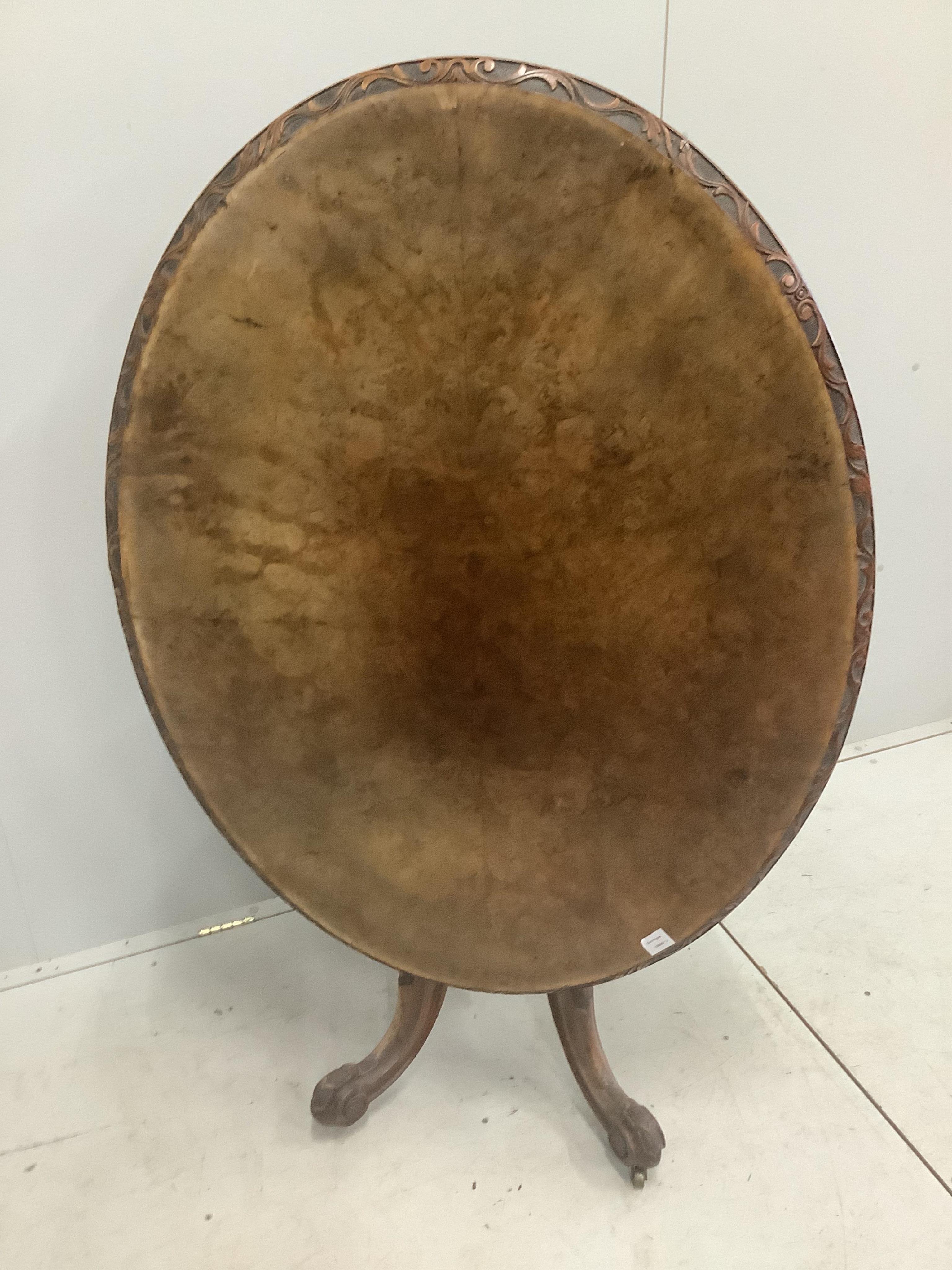 A Victorian carved walnut oval tilt top breakfast table, 120 x 92cm, height 72cm. Condition - fair